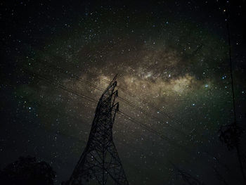 Low angle view of silhouette tree against sky at night