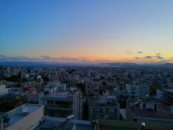 High angle shot of cityscape against blue sky