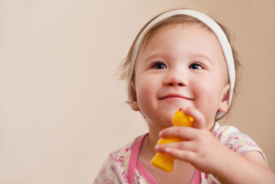 Portrait of cute girl eating baby