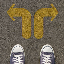 Low section of man standing on road