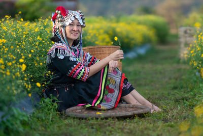 Full length of woman sitting on field