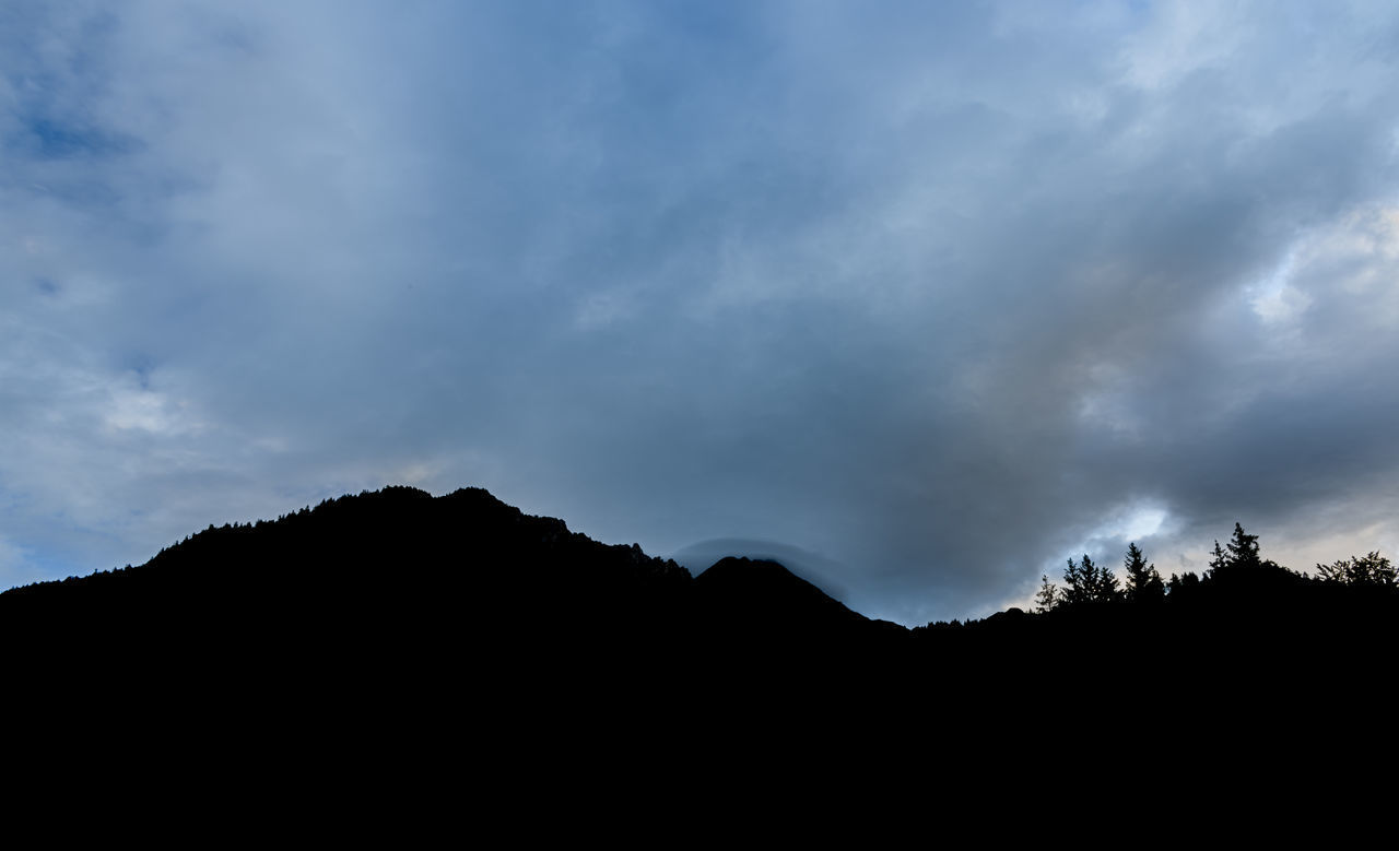 SILHOUETTE OF MOUNTAIN RANGE AGAINST SKY