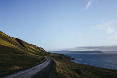 Road by sea against sky