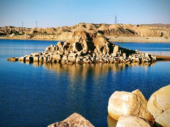 Panoramic view of rocks in sea against clear sky