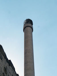 Low angle view of smoke stack against sky