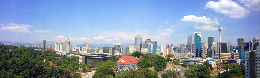 Skyscrapers against cloudy sky