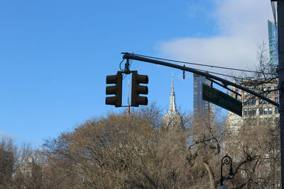 Low angle view of road sign against sky