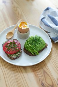 High angle view of open sandwich and boiled egg on plate