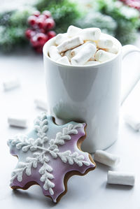 Christmas cocoa, gingerbread cookies and decorations. white wooden background.