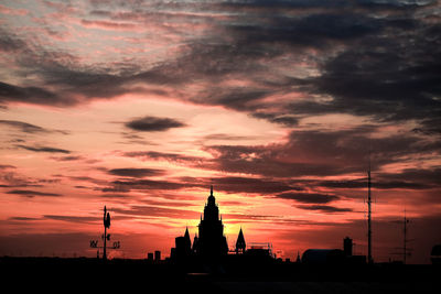 Silhouette of building against cloudy sky during sunset