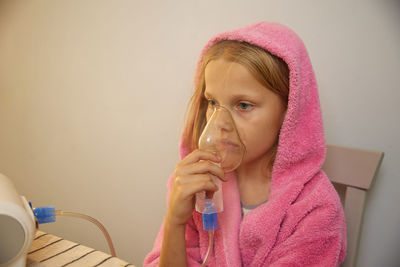 Little girl using inhaler - respiratory problems