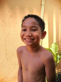 Portrait of smiling shirtless boy