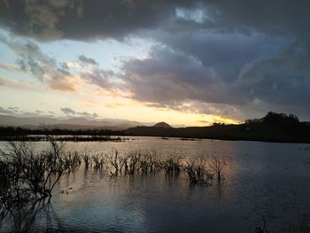 Scenic view of lake against sky during sunset