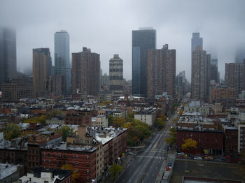 High angle view of street amidst buildings in city against sky