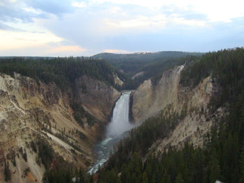 Scenic view of waterfall against sky