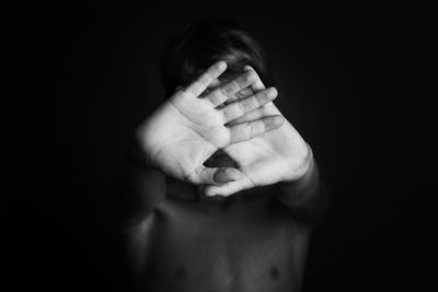 Close-up of human hand against black background