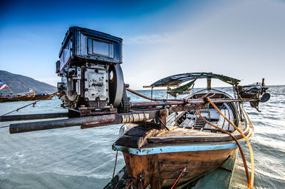 Abandoned ship moored on sea against sky