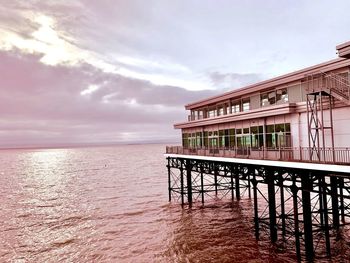 Building by sea against sky