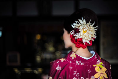 Rear view of woman wearing flowers