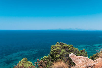 Scenic view of sea against clear blue sky