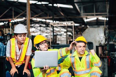 Engineers looking away in factory