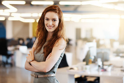 Portrait of smiling businesswoman standing in office