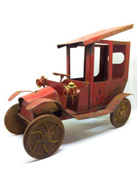 Close-up of red toy car against white background