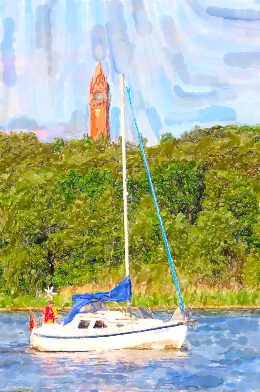 VIEW OF SAILBOAT IN LAKE AGAINST TREES