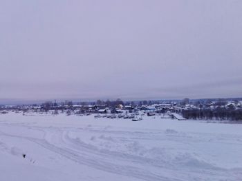 Frozen landscape against clear sky