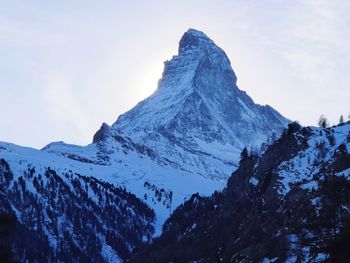 Scenic view of snowcapped mountains against clear sky