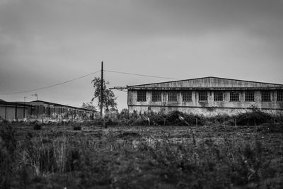 Abandoned building on field against sky