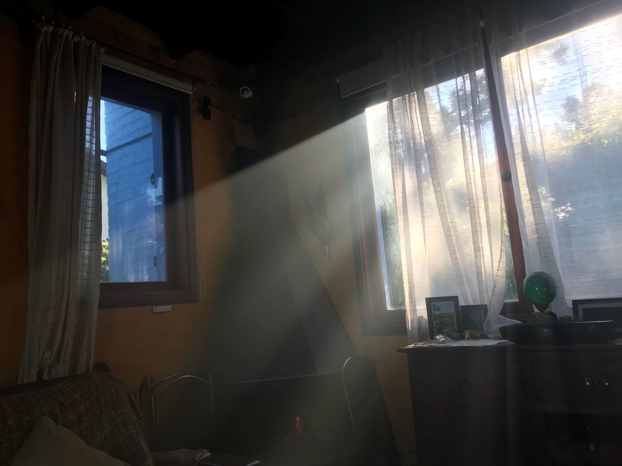 SUNLIGHT STREAMING THROUGH GLASS WINDOW