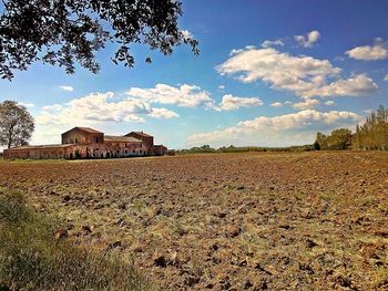 Houses on field against sky