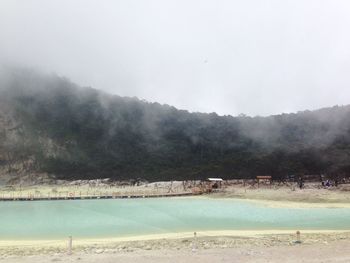 People on mountain against sky