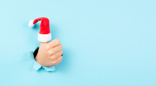 Thumb up, santa claus hat, christmas holiday, positive hand gesture, optimism and emotion, winter 
