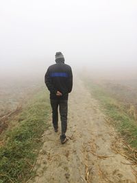 Full length of man standing on foggy day