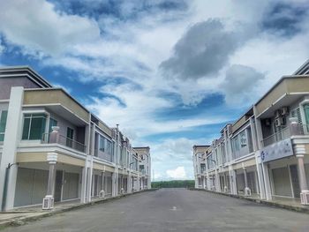 Street amidst buildings against sky