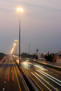 The busy road on the interstate highway with traffic headlight motion in the morning light