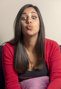 Portrait of beautiful young woman over white background