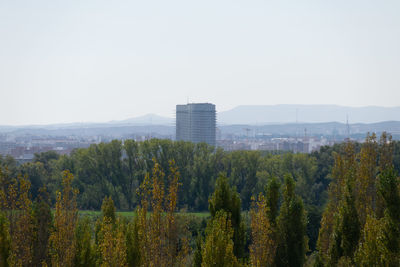 Panoramic view of trees and buildings against clear sky