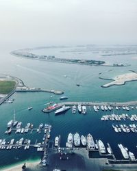 High angle view of boats moored in sea against sky
