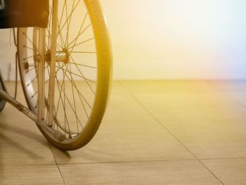 Cropped image of wheelchair on tiled floor