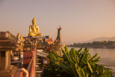 Statue of temple against building