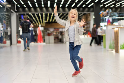 Portrait of happy girl standing in store