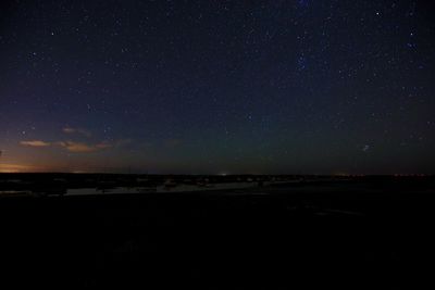 Scenic view of beach against starry sky