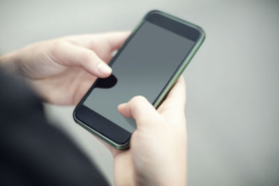 Cropped image of woman using smart phone