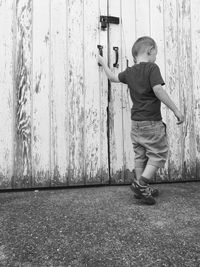 Full length of girl standing against wall