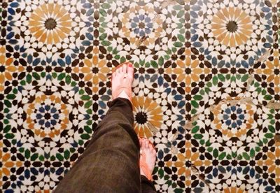 View of human feet on tiled floor