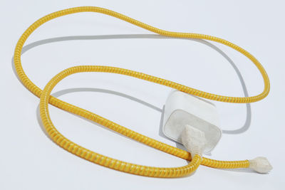 High angle view of yellow wheel against white background