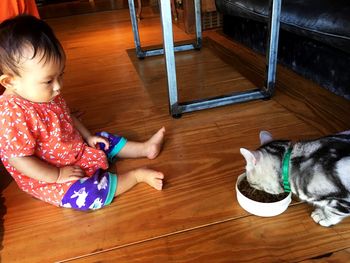 High angle view of girl lying on floor at home